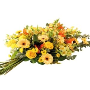 Homenaje de luz y serenidad. La Gerba Atardecer es una composición artesanal confeccionada íntegramente en mano, sin soporte de agua ni esponja. Un diseño sobrio en tonos amarillos y naranjas que simboliza el recuerdo cálido y el agradecimiento eterno.